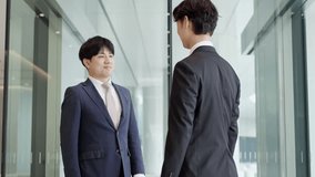 Asian businessmen shaking hands in a lobby - Powered by Shutterstock - Get 15% off with code: PIKWIZARD15