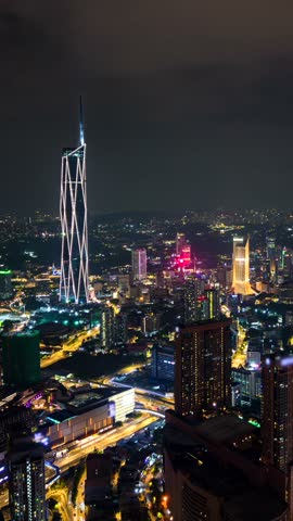Aerial timelapse of traffic and the Kuala Lumpur city skyline at night, Malaysia.