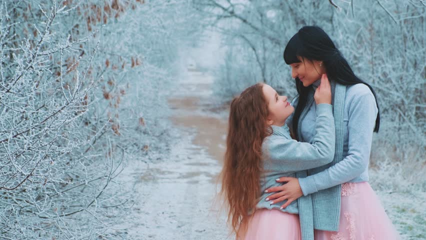 happy family mother and daughter posing for photo shoot, look into each other