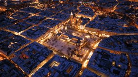 Winter wonderland in Krakow's market square with Saint Mary Basilica illuminated at night - Powered by Shutterstock - Get 15% off with code: PIKWIZARD15