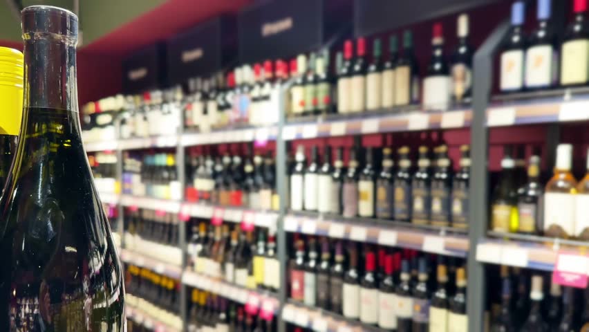 defocused alcohol (wine, champagne, liquor, whiskey) on store shelves