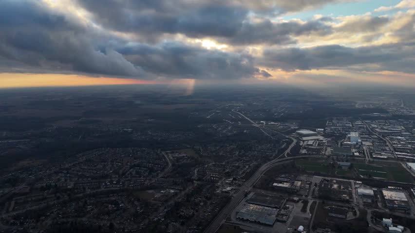 An aerial view captures the beauty of the city of Kitchener, Ontario nestled under a serene blanket of clouds at sunset time in Canada