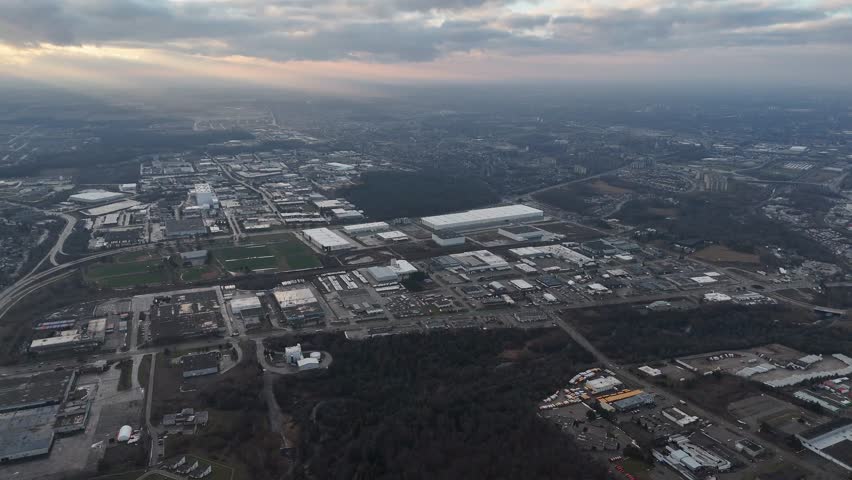 An aerial view captures the beauty of the city of Kitchener, Ontario nestled under a serene blanket of clouds at sunset time in Canada