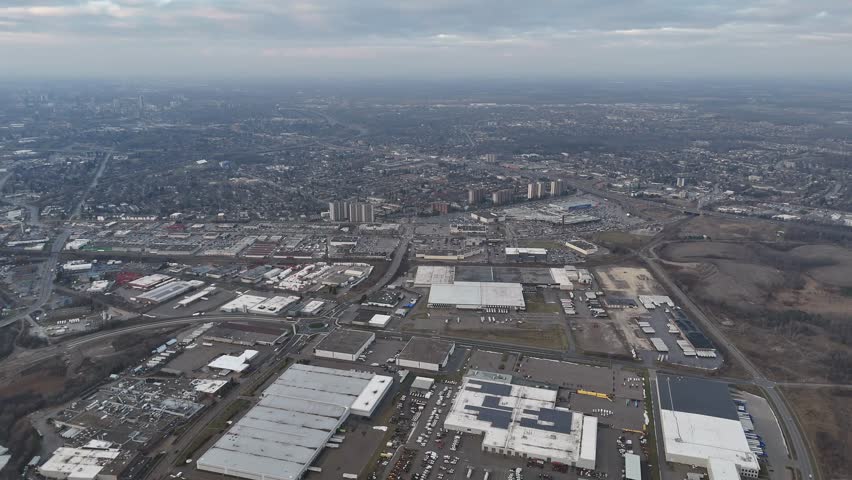 A drone footage of dramatic cloudy sky above the urban Kitchener, Ontario cityscape in Canada