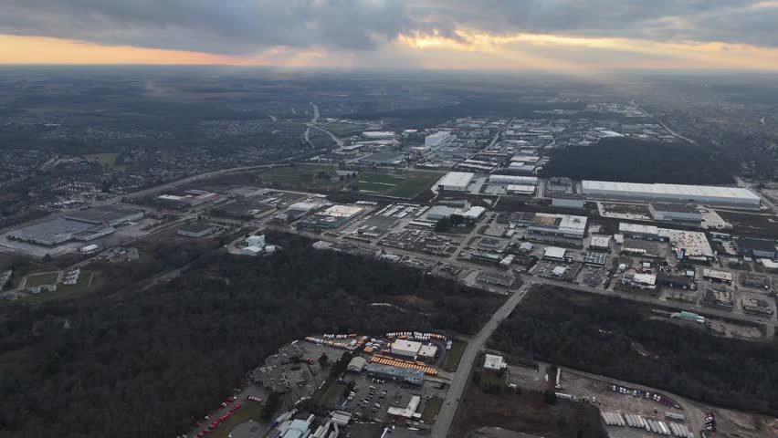 An aerial view captures the beauty of the city of Kitchener, Ontario nestled under a serene blanket of clouds at sunset time in Canada