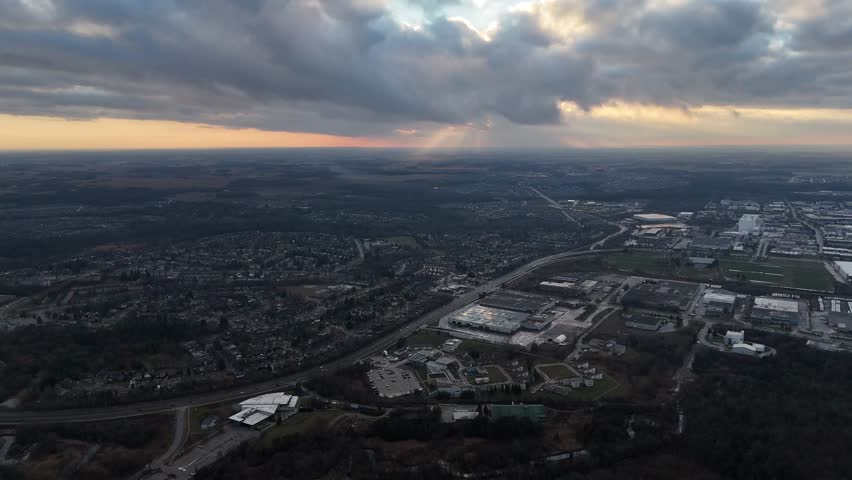 An aerial view captures the beauty of the city of Kitchener, Ontario nestled under a serene blanket of clouds at sunset time in Canada