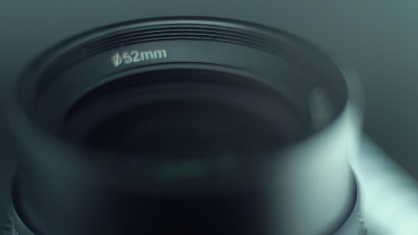 Low aperture camera optic lens flare Macro slow motion video tilt down movement, 120 fps