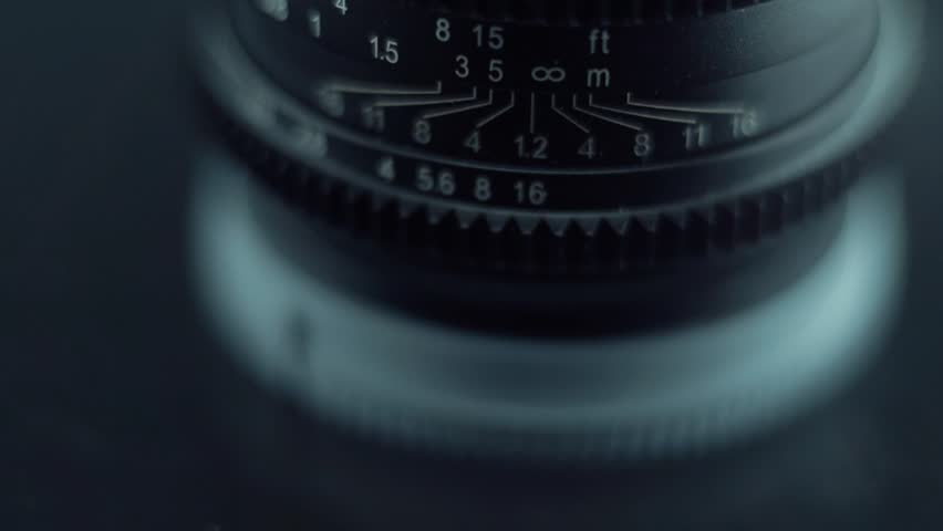 Low aperture camera cine optic lens flare Macro slow motion video tilt up movement, 120 fps