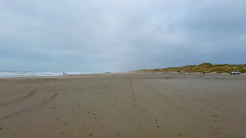Beautiful Danish coastline landscape in the summer. Danish Coast. Dune grasses frame the coastline in the north of the west coast of Denmark. Landscape of a dry open field by the sea. Lovely Sunny day