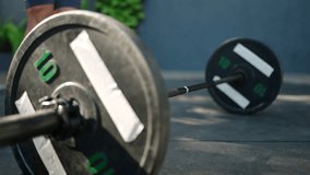 Fitness enthusiast lifts heavy barbell at outdoor gym. Muscular female focuses on strength training, deadlifting weights. Healthy lifestyle, empower, sport outdoor workout for dedicated athlete. Slomo - Powered by Shutterstock - Get 15% off with code: PIKWIZARD15