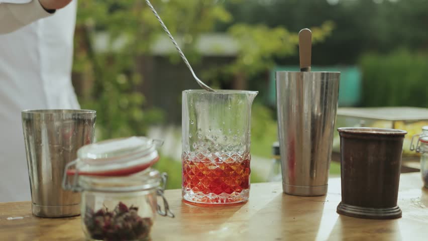 Crafting a Beautiful and Colorful Cocktail Outdoors Using Professional Bartending Techniques