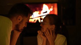 A heartfelt moment of a couple sharing an affectionate gaze near the warmth of a glowing fireplace. The soft light enhances their emotional connection and serene atmosphere - Powered by Shutterstock - Get 15% off with code: PIKWIZARD15