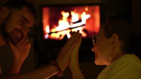 A tender moment shared by a couple near a glowing fireplace. Their eyes meet, capturing a story of love, trust, and the comfort of being together in a serene and cozy setting - Powered by Shutterstock - Get 15% off with code: PIKWIZARD15