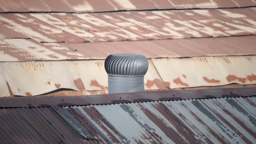 Roof Top turbo air ventilator rotating over a tin shade of a repairing site