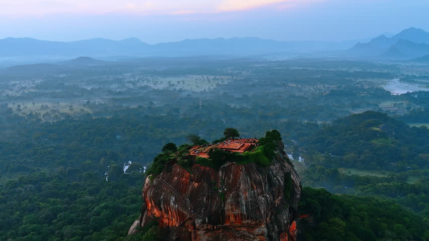 Stunning unusually-shaped brown mount with flat top. Ruins of ancient Sigiriya fortress or Lion Rock in Sri Lanka. Aerial view.