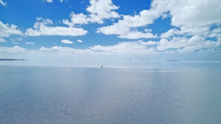 An endless sky and clouds reflected on the water. This unique video evokes a sense of infinity, capturing the peaceful beauty of nature. A minimalist and captivating shot.