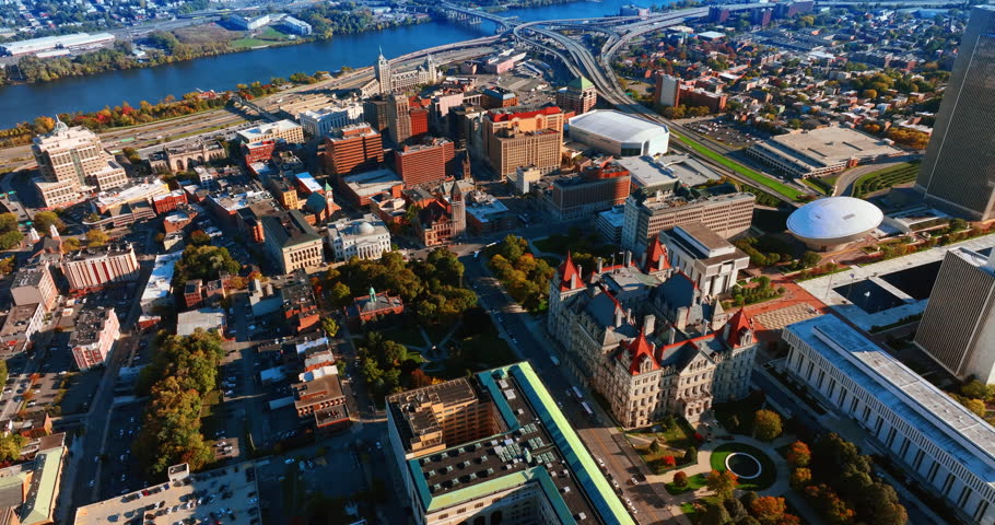 Approaching downtown of a beautiful Albany, New York, USA. Blue river with bridge over it at backdrop. Aerial view.