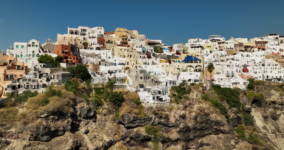 Close flyover above Oia village in Santorini Island. Famous landmark in Greece