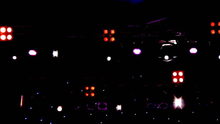 Blinking and moving lighting equipment (spotlights) on stage during a concert of