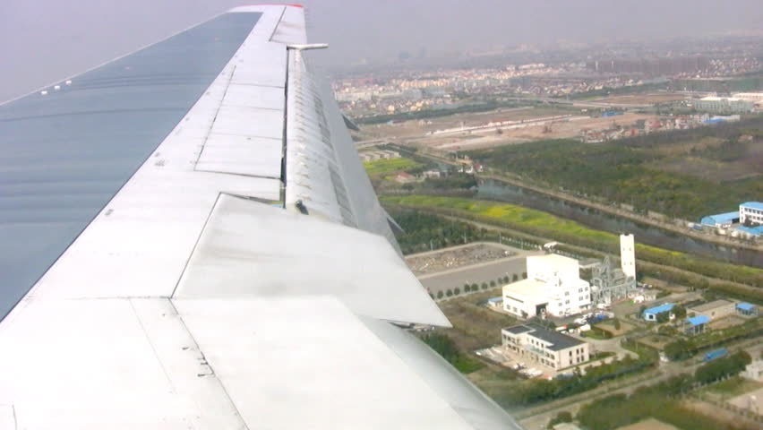Landing of aircraft at the airport in Shanghai. A view from the porthole on the