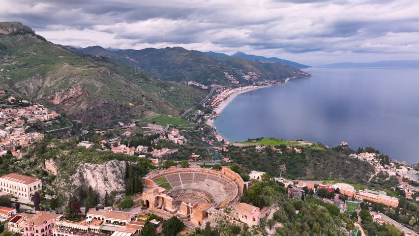 Aerial view of Breathtaking view of ancient theater overlooking the coastline and sea at sunrise in Taormina, Sicily. Italy