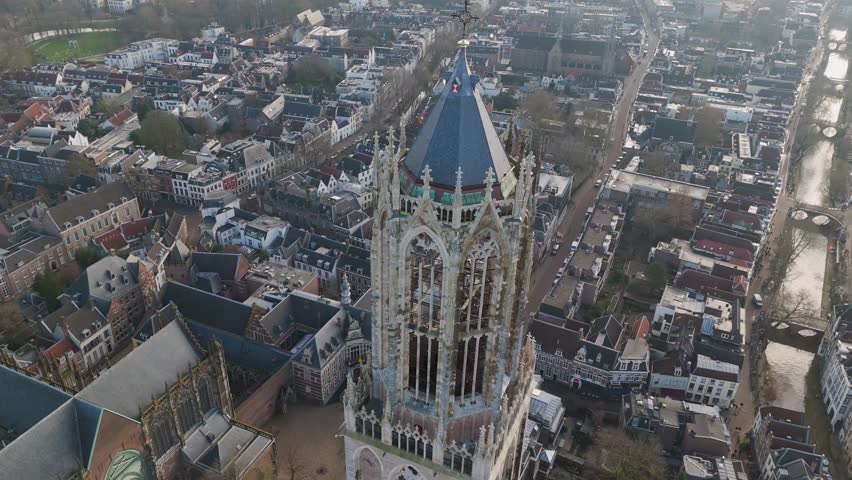 This aerial drone video shows the Dom tower which is a cathedral and clock tower in the historical town center of Utrecht, the Netherlands.