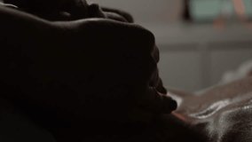 A masseur gives a facial, neck and shoulder massage to a young woman in a spa salon by candlelight. - Powered by Shutterstock - Get 15% off with code: PIKWIZARD15