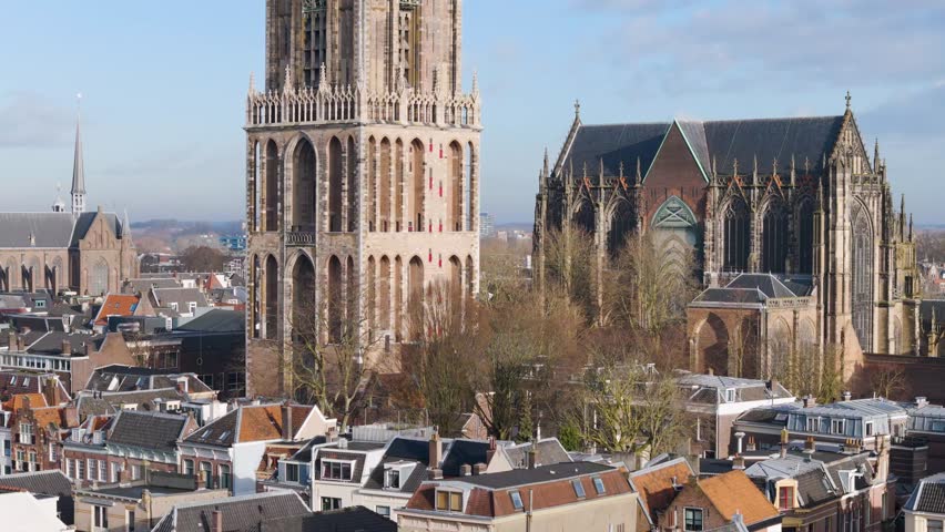 This aerial drone video shows the Dom tower which is a cathedral and clock tower in the historical town center of Utrecht, the Netherlands.