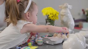 Happy Easter. Mother and child with bunny ears preparing for the holiday. Painting eggs - Powered by Shutterstock - Get 15% off with code: PIKWIZARD15