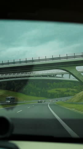 Empty winter road surrounded by towering snow banks leads towards snowy mountain. Trees and road are covered with fresh snow, which promises amazing day for powder riding in Poland Pieniny Mountains