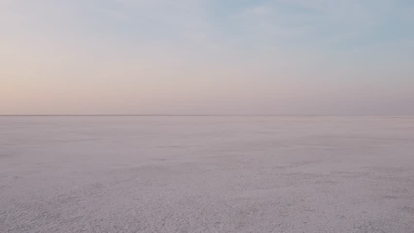 4K Aerial shot of salt flats at rann of Kutch during sunrise. White desert of Kutch in Gujarat, India. Aerial view over the expansive salt marsh of The Great Rann of Kutch. Tranquil Nature landscape. 