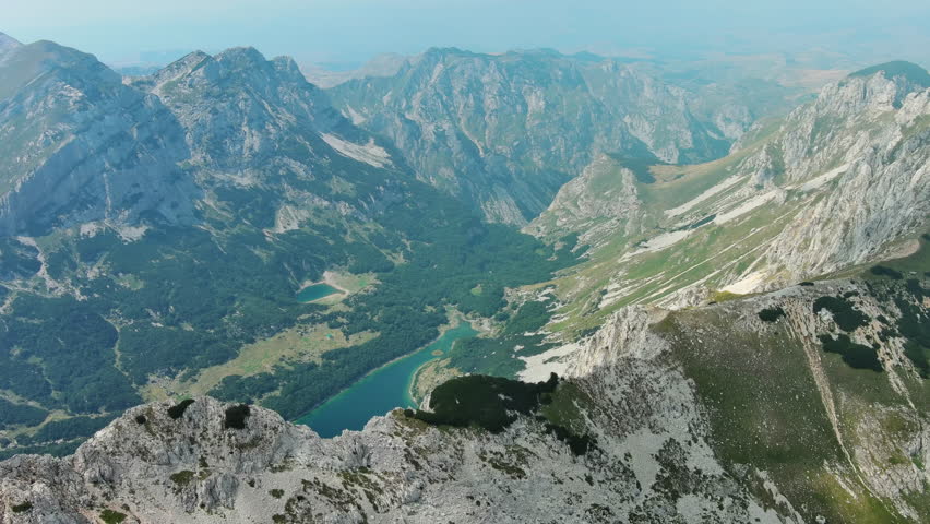 Flying in mountains. Lake in Durmitor National park in Montenegro. Beautiful aerial mountain landscape, 4k
