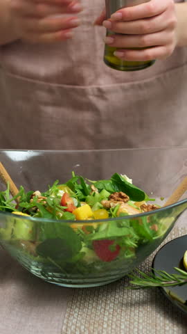 add olive oil to salad seafood lobster Hands only Caucasian home kitchen counter slicing organic fresh salad vegetables wireless tablet recipe healthy lifestyle eating