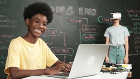 Smart african student programming and coding innovative system while caucasian girl enter in metaverse or virtual world by using VR or head set at blackboard in STEM technology classroom. Edification - Powered by Shutterstock - Get 15% off with code: PIKWIZARD15