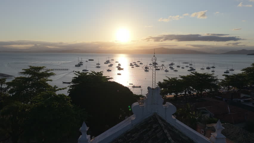 Idyllic Sunset Over Santo Antônio de Lisboa Harbor With Boats and Silhouetted Trees. Drone.