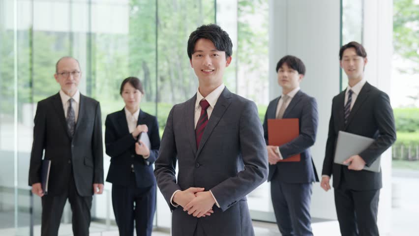 Asian businessman standing with a smile