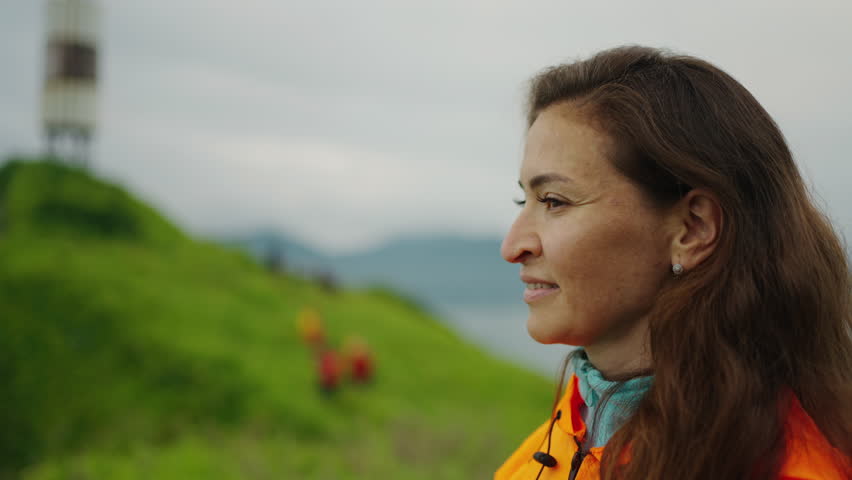 Middle-Aged Hispanic Woman Traveling To North, Portrait At Mount Of Cape In Ocean, Trip To Islands