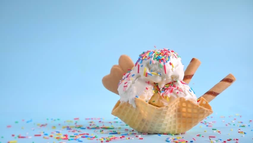 vanilla ice cream scoops in bowl with strewing sprinkles