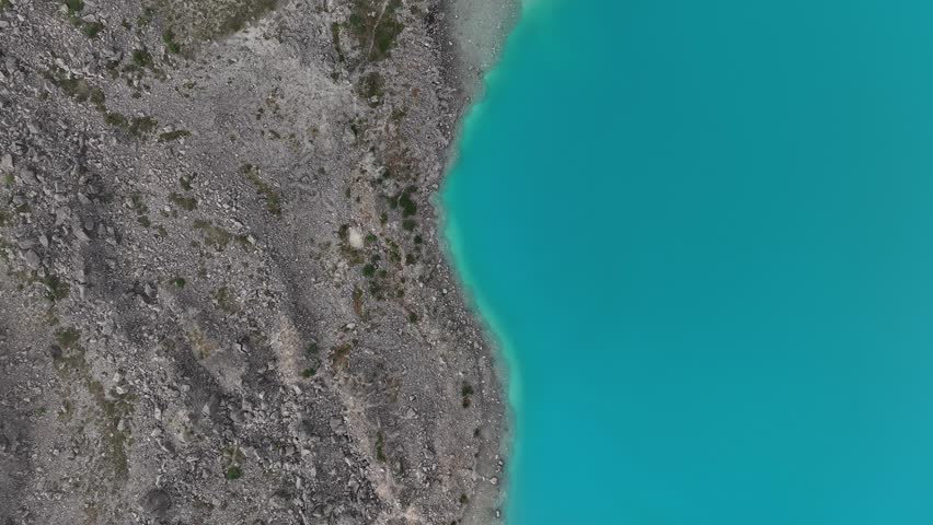 A drone footage of the Blaisvatnet lake (The Blue Lake) in Svensby, Lyngen, Troms county, Norway, on a sunny day