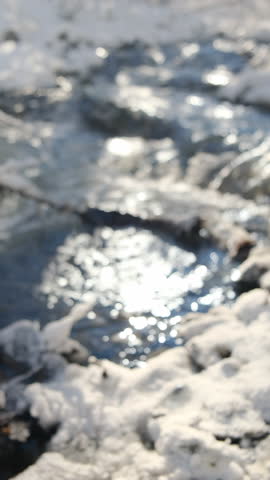 Vertical footage of people clink mugs with hot mulled wine on background clean mountains river and winter forest at sunny day. Traditional drink on winter holiday