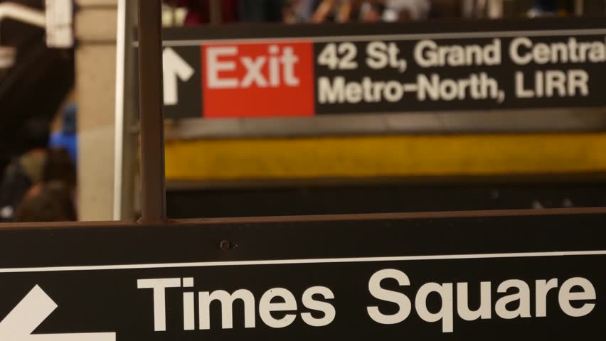 New York subway station interior, underground metropolitan platform. United States public metro transportation. Railway hub, passenger traffic junction. Text on sign Times Square, Grand Central, 42 St