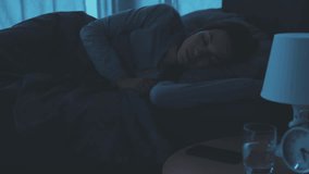 Woman waking up and turning off the alarm on her smartphone - Powered by Shutterstock - Get 15% off with code: PIKWIZARD15