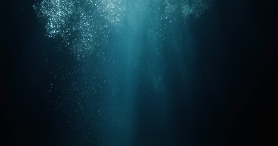 Stunning 4K slow-motion footage of underwater god rays piercing the ocean surface, with enchanting beams of light flickering. Ideal VFX background for diving, snorkeling, and summer adventures.