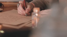 Close up of girl's hand writing calligraphy with ink pen. Professional calligrapher writing a letter. Art of penmanship.  - Powered by Shutterstock - Get 15% off with code: PIKWIZARD15