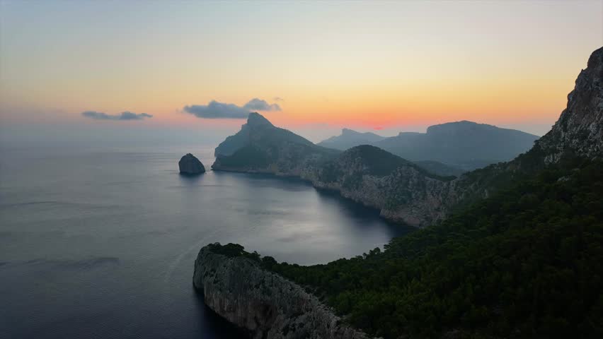Sunrise on Mirador de Es Colomer, Camera view of rocky cliff, sea and Lighthouse on Formentor, Mallorca, Spain. 4K Timelapse video.