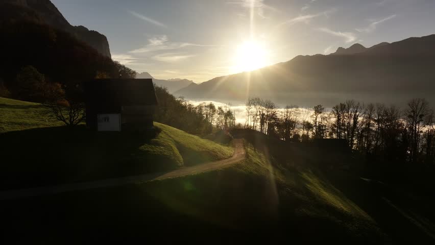 Sunrise over Walensee with a hilltop house and trees in Switzerland's serene landscape