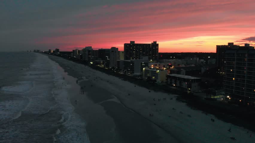 Aerial view of Myrtle Beach coastline and buildings from drone at sunset, South Carolina