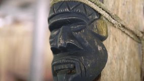 Wooden mask in front of a cottage in Colombia. ancient totems. - Powered by Shutterstock - Get 15% off with code: PIKWIZARD15