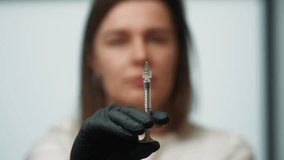 Medical Syringe Needle Releasing Liquid in a Doctor Hands During Treatment Procedure. High quality 4k footage - Powered by Shutterstock - Get 15% off with code: PIKWIZARD15