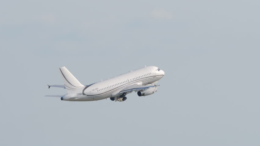 Footage of a passenger plane with white livery taking off. Jet airplane departure. Aeroplane in the sky, long shot, side view. Travel concept